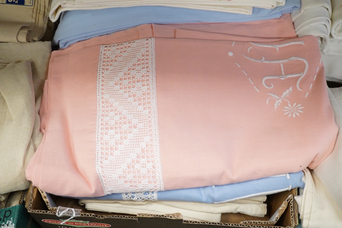 Thirteen mixed French mostly coloured provincial linen sheets some embroidered with monograms, floral embroidery, or decorated with crochet.